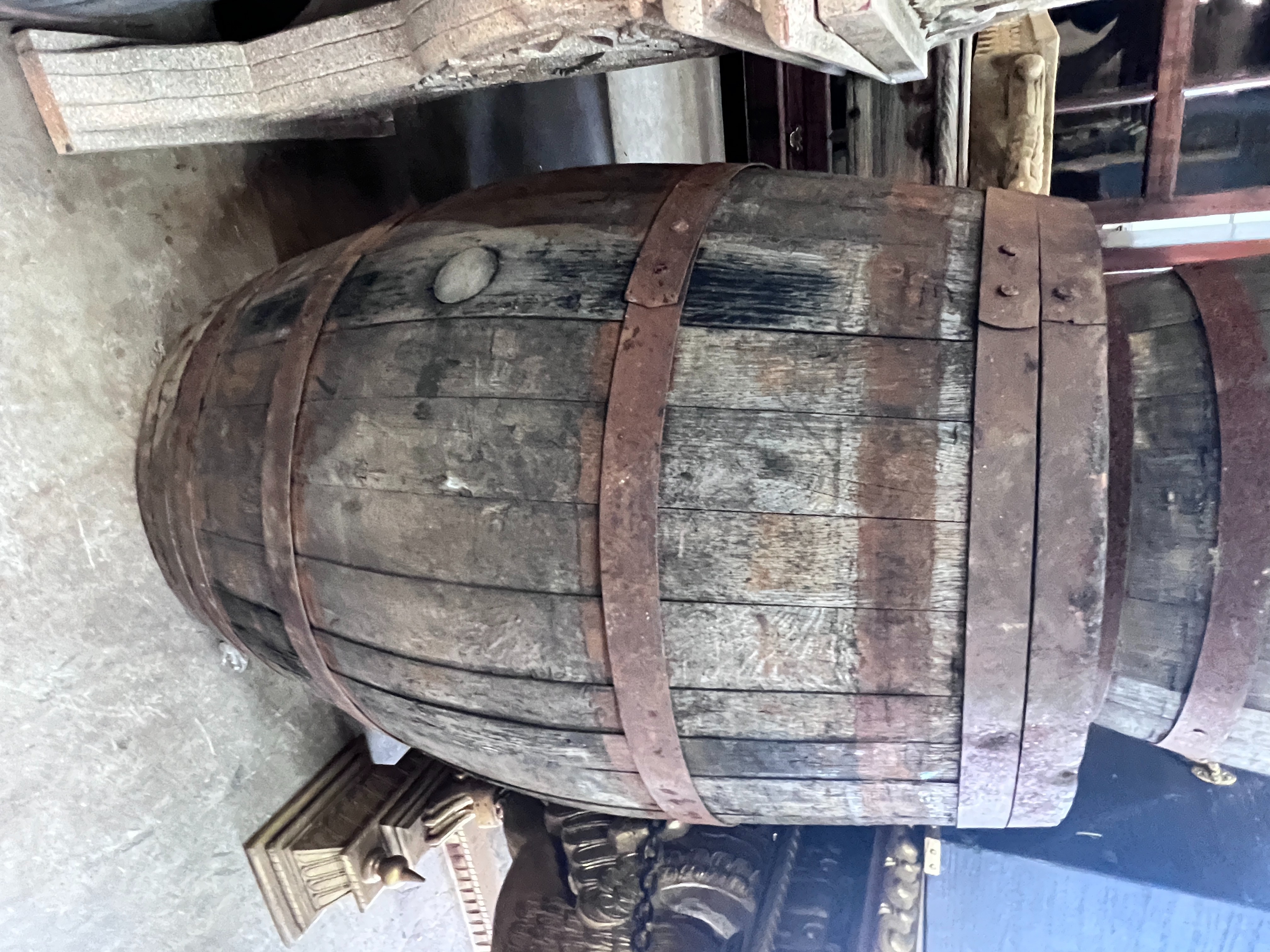 Three iron bound staved wood barrels, largest height 98cm